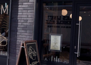 Front view of ADAM Grooming Atelier - Fitzrovia, London, England, GB showcasing modern design and signage.