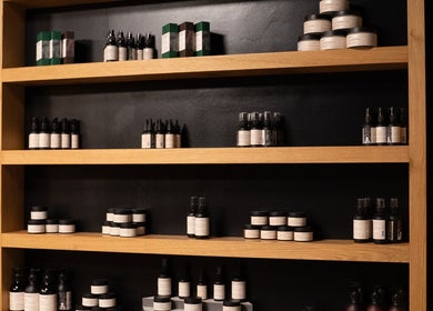 Elegant product display shelves at ADAM Grooming Atelier - Fitzrovia, London, England, GB.