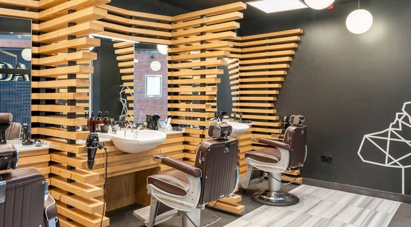 ADAM Grooming Atelier - St Paul's showcases sleek barber chairs in London, England, GB interior.
