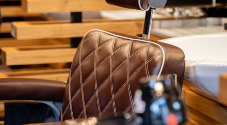 Luxurious chair at ADAM Grooming Atelier - Marylebone, London, England, GB, showcasing stylish barber setting.