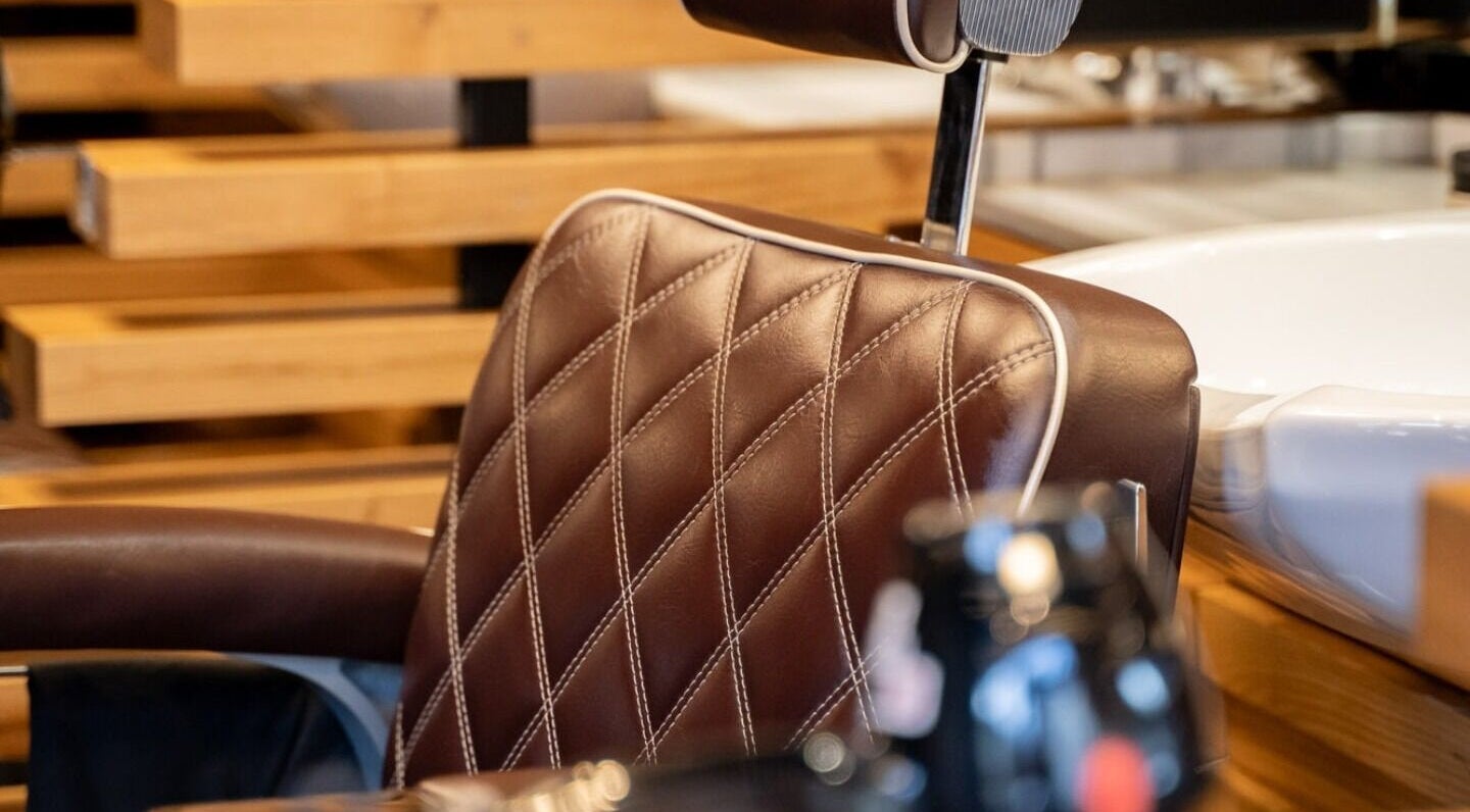 Luxurious chair at ADAM Grooming Atelier - Marylebone, London, England, GB, showcasing stylish barber setting.
