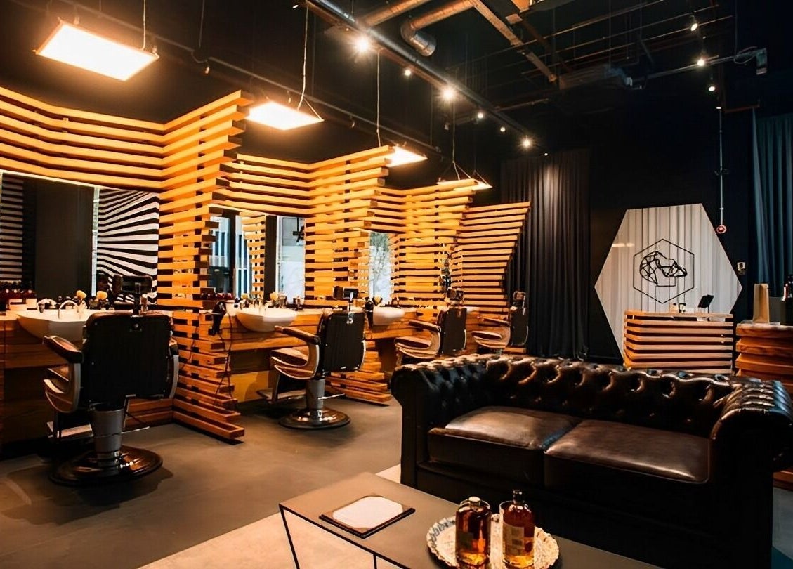 Elegant interior of ADAM Grooming Atelier - Monument, London, England, GB with modern design and classic furnishings.