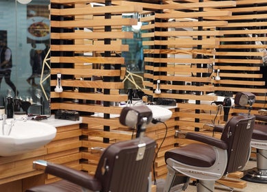 Stylish interior of ADAM Grooming Atelier - Canary Wharf Mall Jubilee Place, London, England, GB.