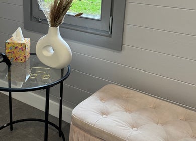 Modern decor at LS Beauty By Lauren, Watford, England, GB featuring elegant seating and a stylish table.