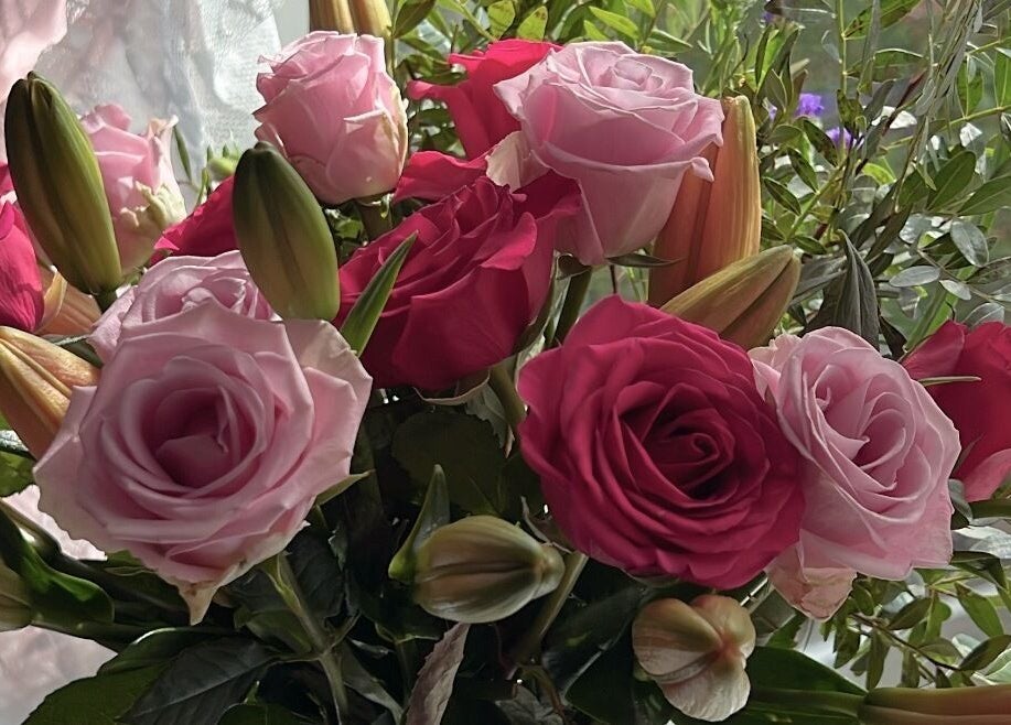 Elegant floral arrangement at Faces Enhanced, Nottingham, England, GB, showcasing vibrant roses.