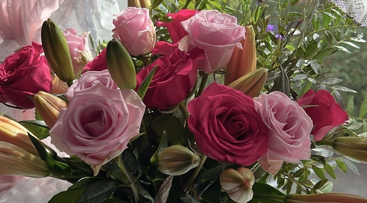 Elegant floral arrangement at Faces Enhanced, Nottingham, England, GB, showcasing vibrant roses.