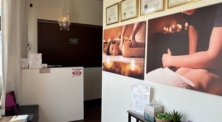 Reception area of Relax Thai Spa in Redondo Beach, California featuring elegant decor and massage imagery.