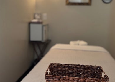 Massage room at Relax Thai Spa in Redondo Beach, California, US with a cozy bed and basket.