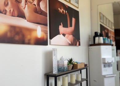Relax Thai Spa lobby wall decor in Redondo Beach, California, US showcasing tranquil massage imagery.