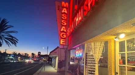 Relax Thai Spa sign glowing at dusk in Redondo Beach, California, US, inviting for a soothing experience.