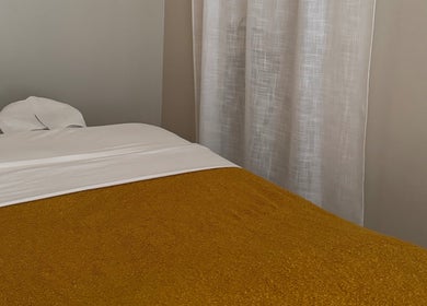 Cozy massage bed in a tranquil room at Relax Thai Spa, Redondo Beach, California, US.