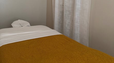 Cozy massage bed in a tranquil room at Relax Thai Spa, Redondo Beach, California, US.