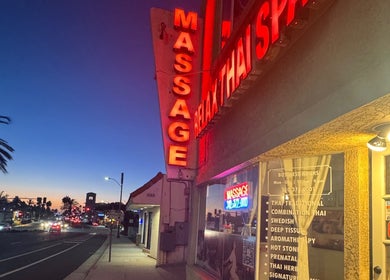Front of Relax Thai Spa in Redondo Beach, California at dusk with bright signage.