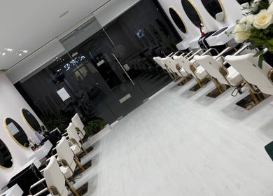 Chic interior of Cmf Hairdressing W6 in London Chiswick, England, GB, featuring stylish salon chairs and mirrors.