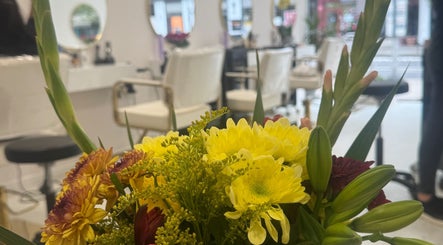Vibrant floral arrangement at Cmf Hairdressing W6, London Chiswick, England, GB enhancing modern salon interior.