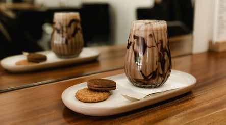 Indulge at Paragon Hair with gourmet drink and cookies, Belgian Gardens, Queensland, AU.
