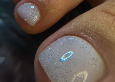 Close-up of glittery white nail art at OF.LAMIMANI, Chicago, Illinois, US.