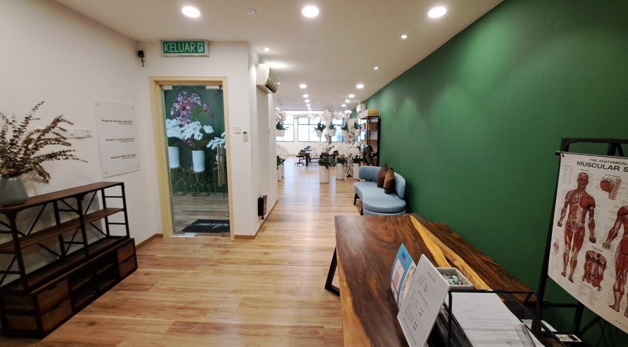 Elegant interior of The Flexologist in Kuala Lumpur, MY, featuring a cozy seating area and green accent wall.