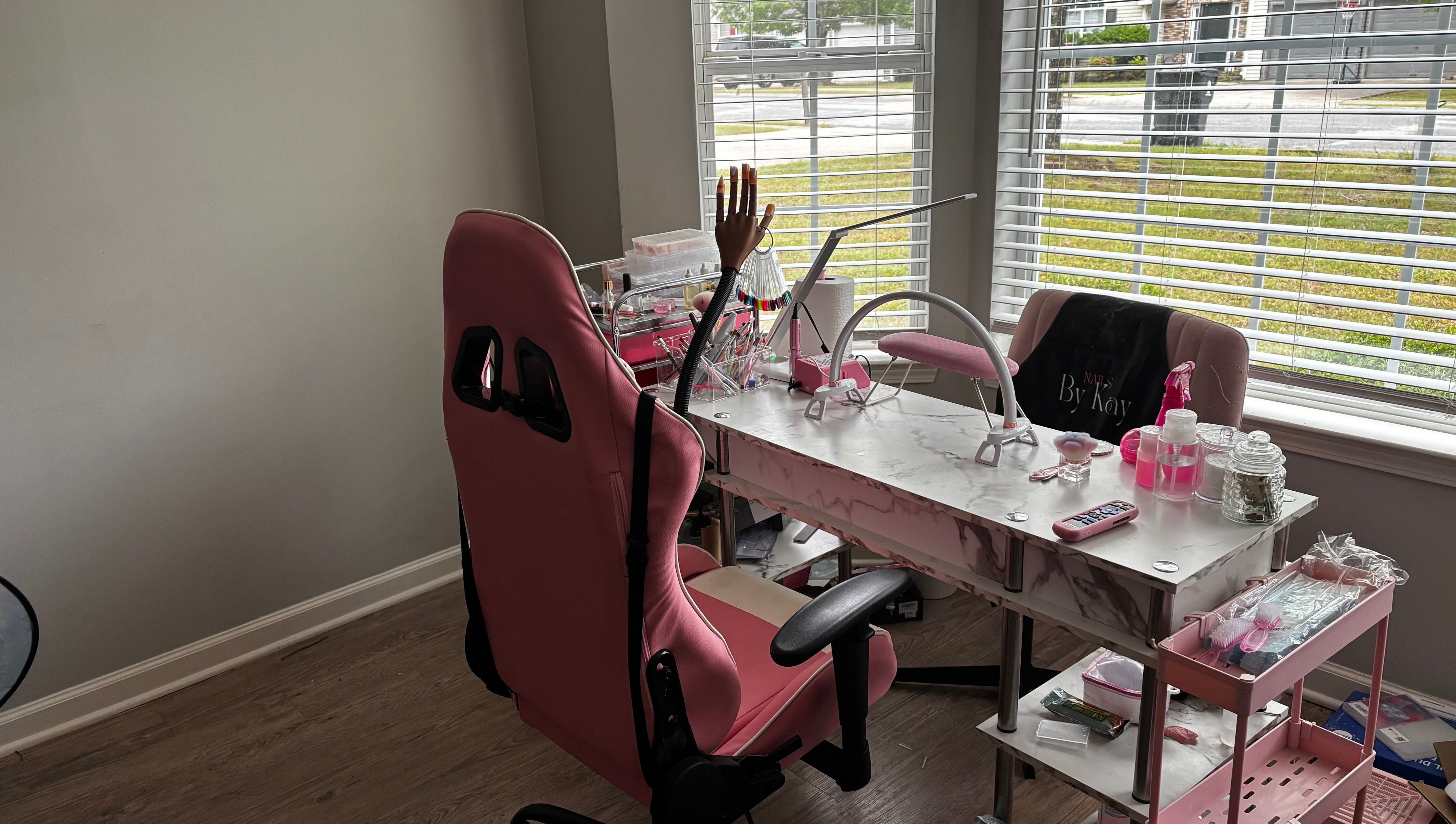 Modern nail station at Nails By Kay, Villa Rica, Georgia, US, featuring pink chairs and a marble table.