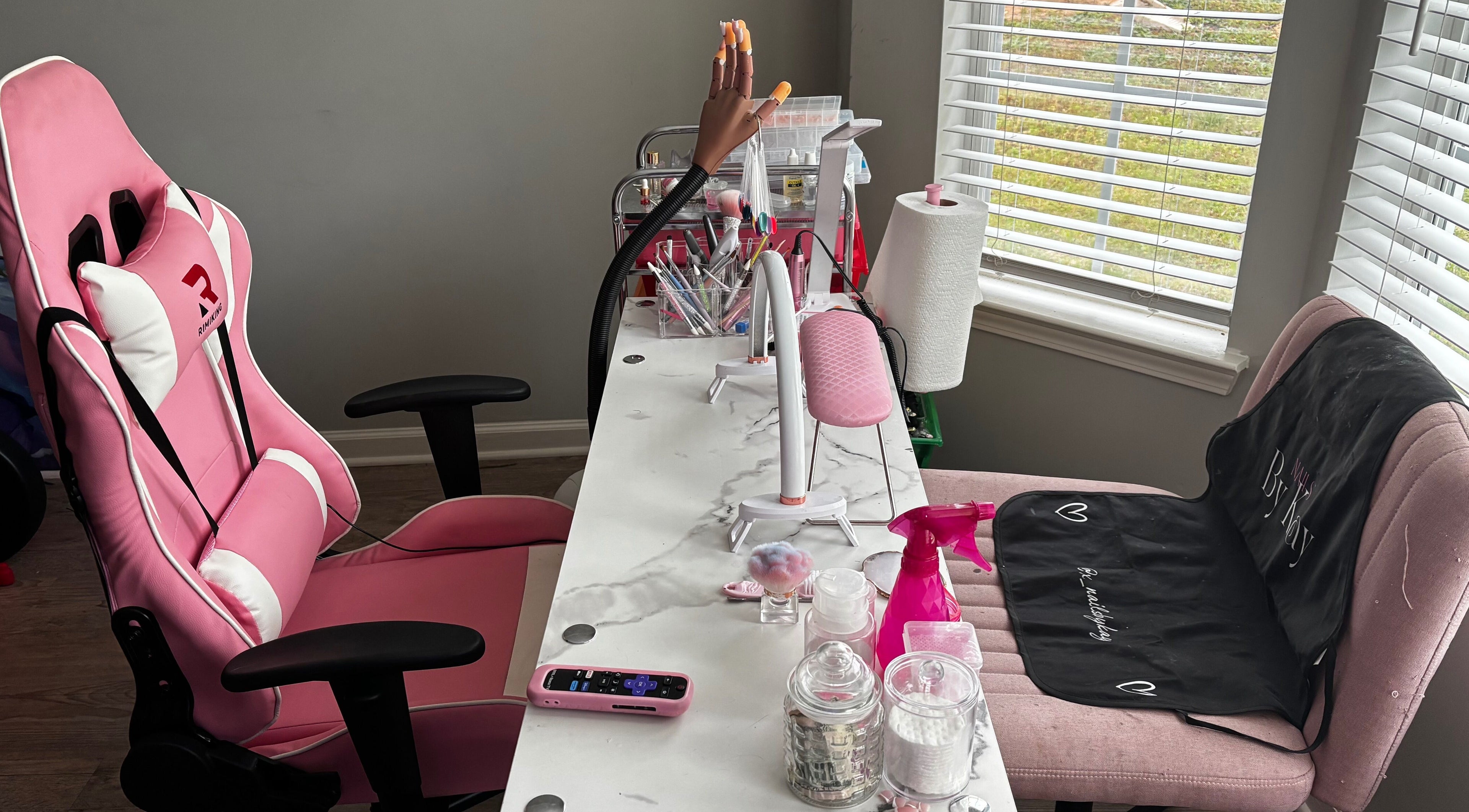 Nails By Kay, Villa Rica, Georgia - a stylish nail station with pink decor and nail tools by the window.