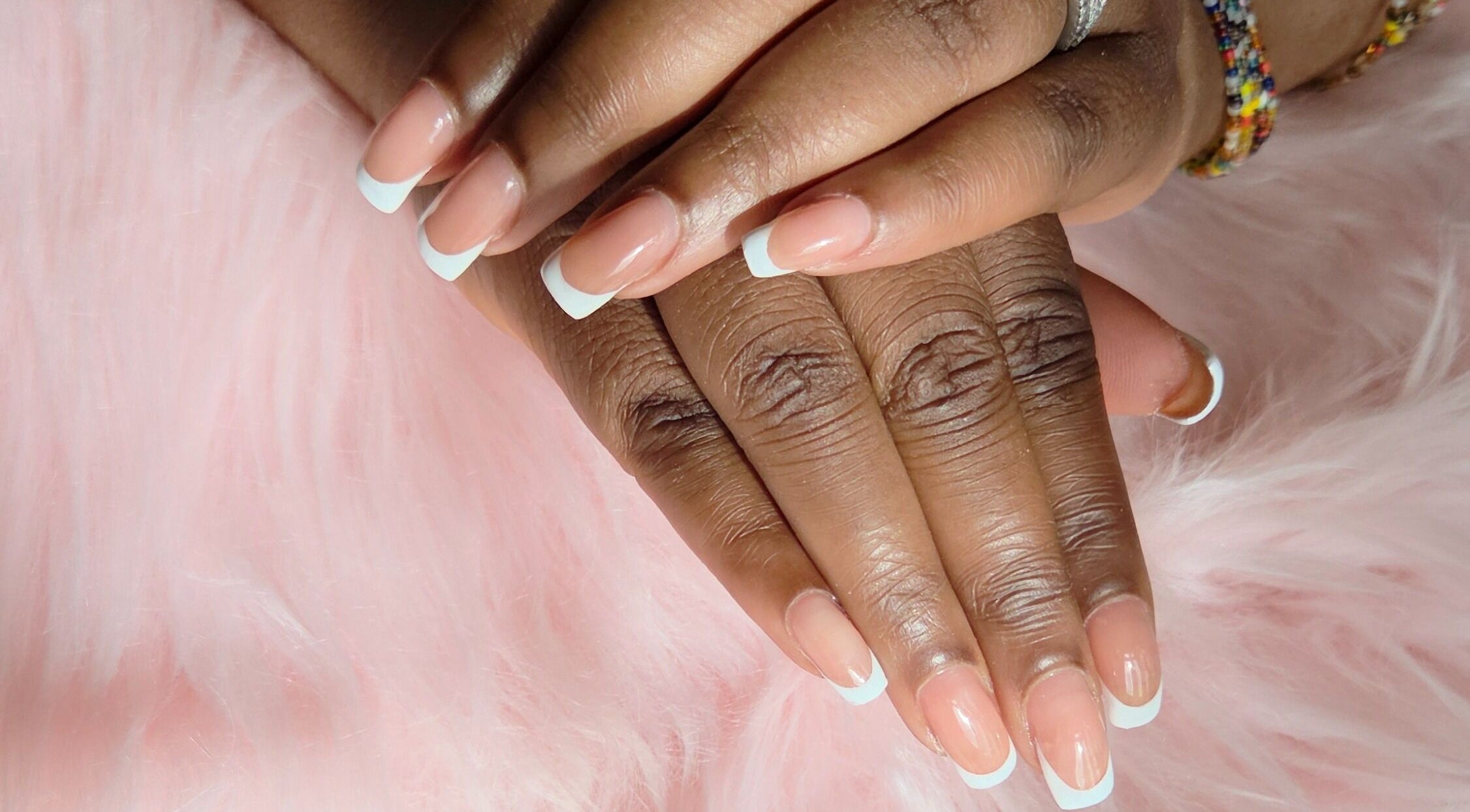 Elegant French manicure by Fab Nails - Mobile Nail Services, Newcastle upon Tyne, England, GB, on a soft pink background.
