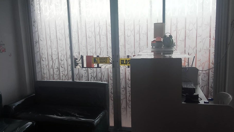 Reception area at Iya Wellness Spa, Bacoor, Calabarzon with bamboo-patterned frosted glass.