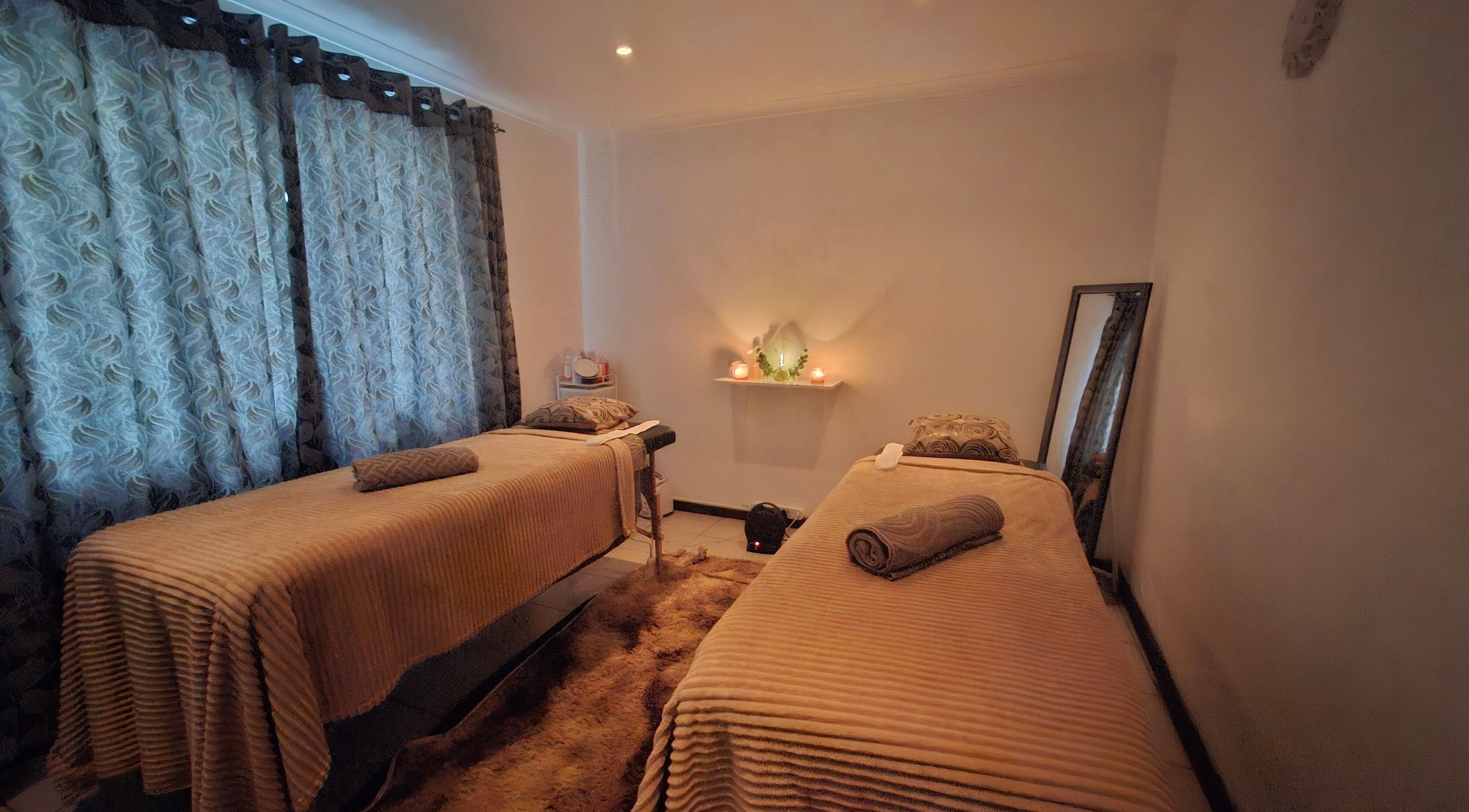 Ivory Waters Beauty Spa massage room in Howick, Kwazulu-natal, ZA with two massage tables.