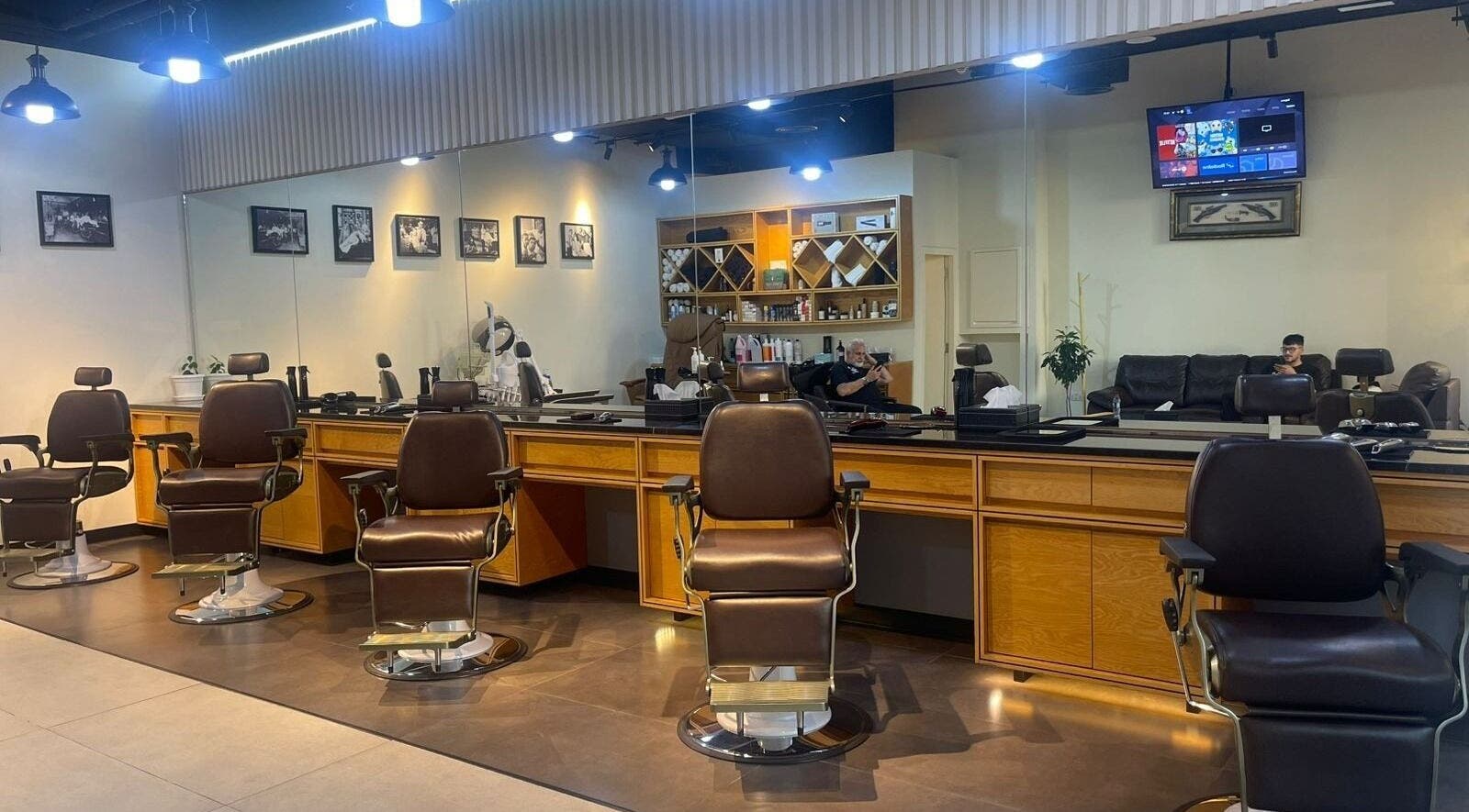 Elegant interior of SLR Gents Salon with modern barber chairs in Dubai, Dubai, AE.