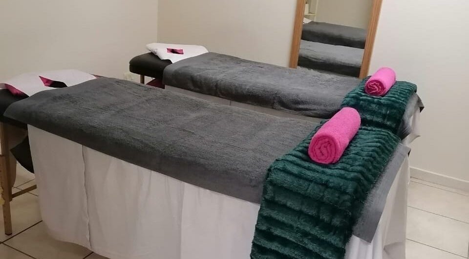 Spa treatment room at Bobbles Beauty Bar, Jeffreys Bay, Eastern Cape, ZA with cozy massage tables and plush towels.