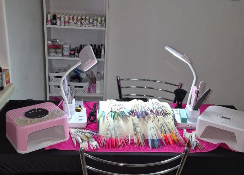 Eksie Perfeksie Naels' vibrant nail art station in Gqeberha, Eastern Cape, ZA with tools and polish colors.