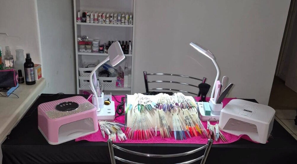 Eksie Perfeksie Naels' vibrant nail art station in Gqeberha, Eastern Cape, ZA with tools and polish colors.