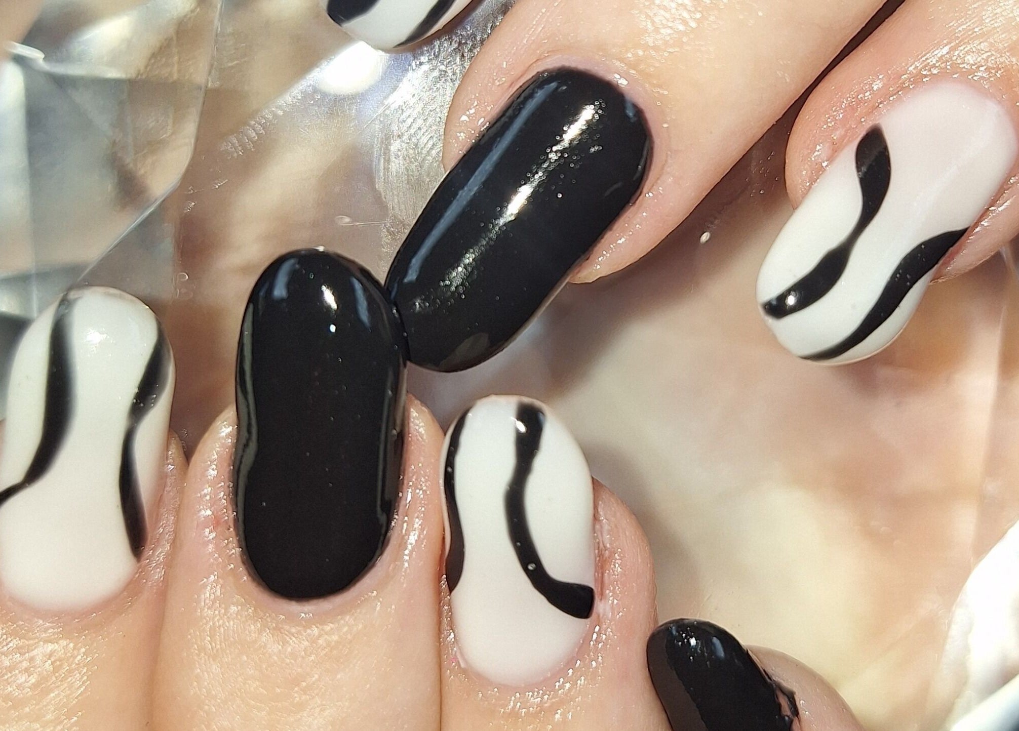 Elegant black and white nail art with wave pattern at Eksie Perfeksie Naels, Gqeberha, Eastern Cape, ZA.