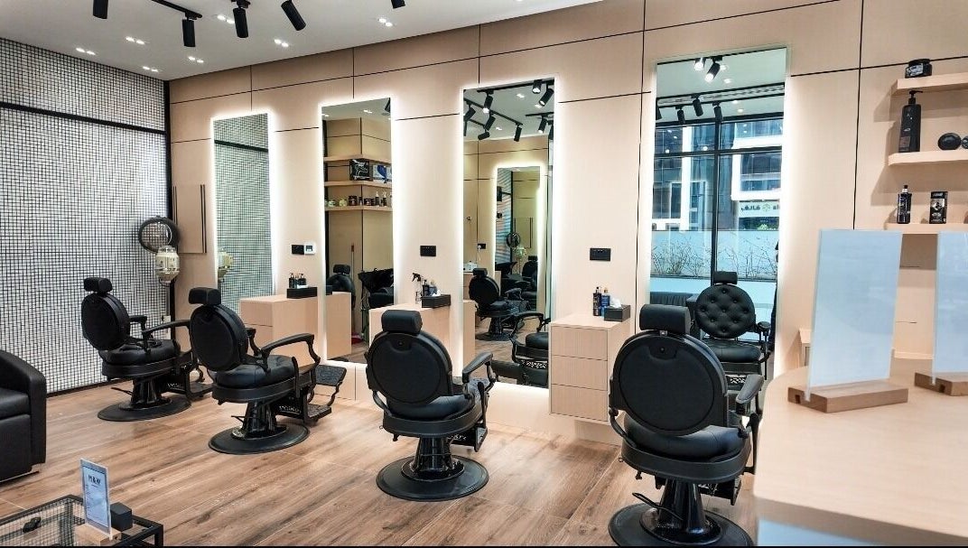 Stylish interior of M&W Gents Salon in Abu Dhabi, Abu Dhabi, AE with barber chairs and modern decor.