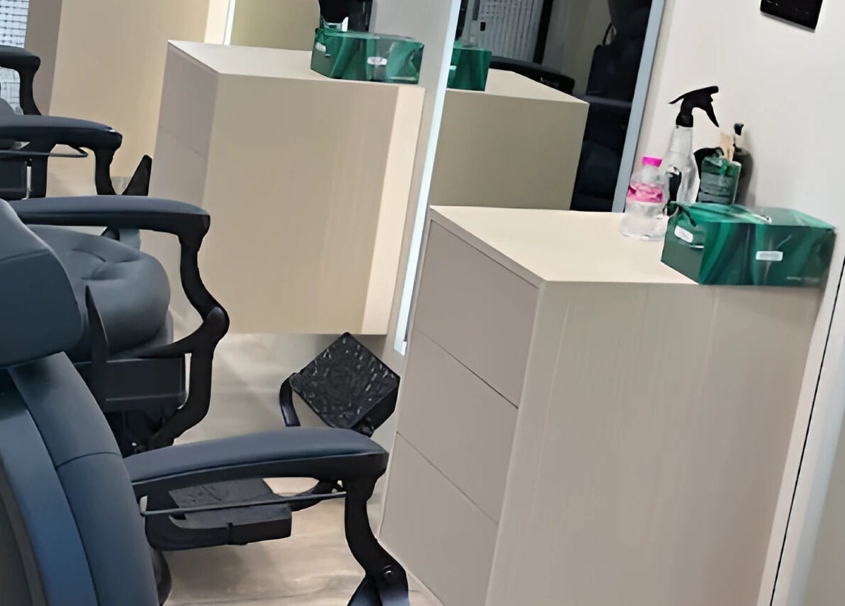 Modern barber chairs in M&W Gents Salon, Abu Dhabi, AE showcase luxury grooming space.