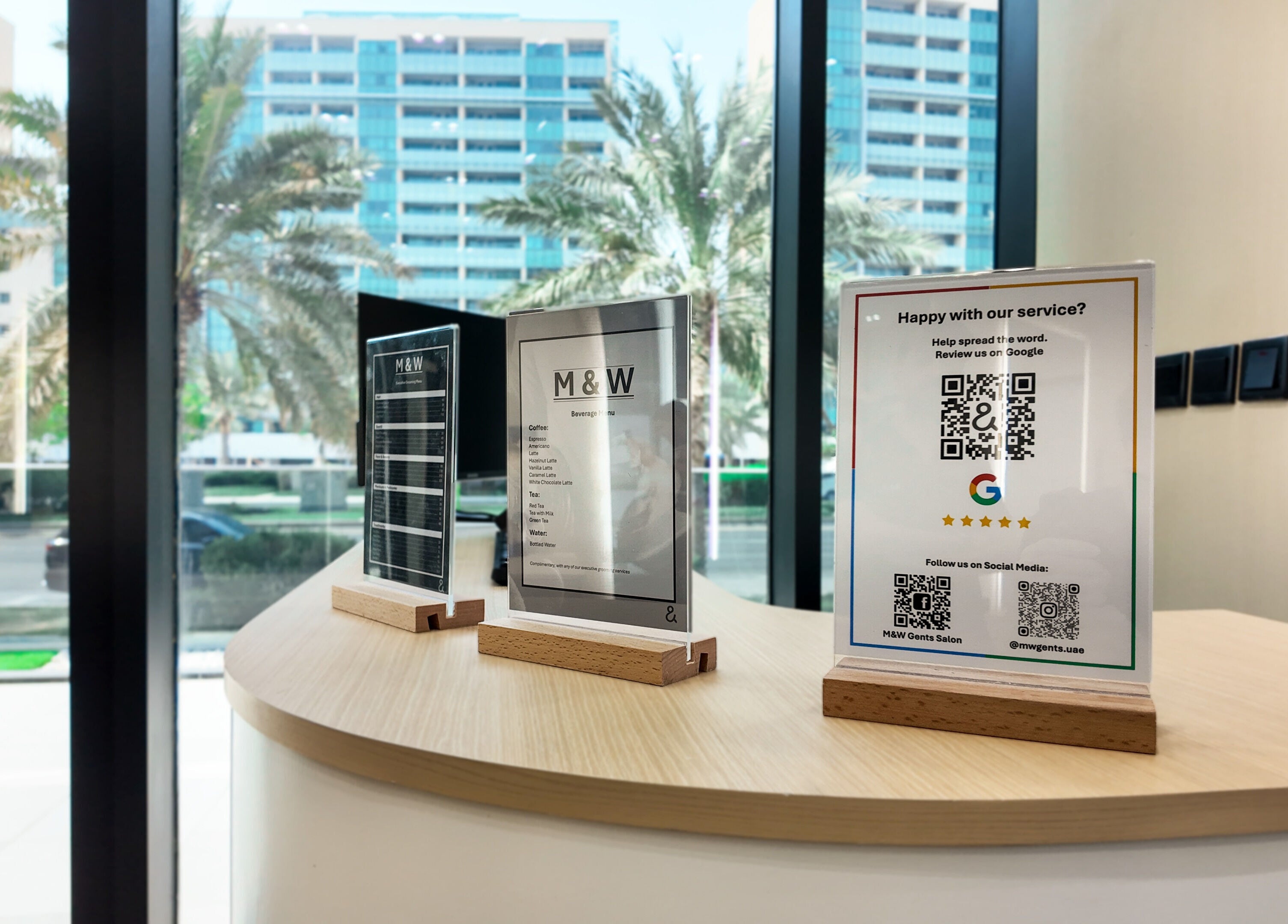 M&W Gents Salon reception with service menu and QR codes, located in Abu Dhabi, Abu Dhabi, AE.