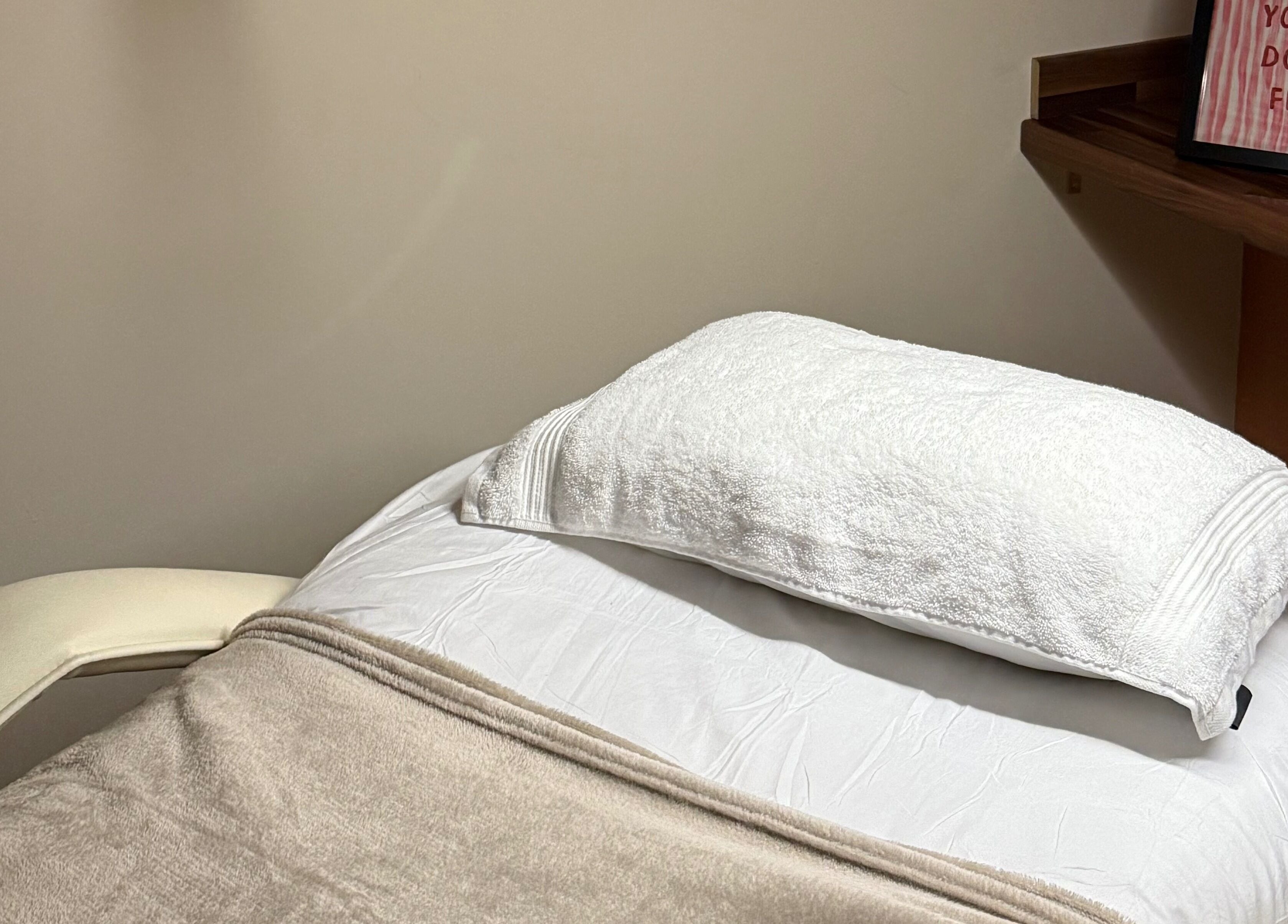 Comfortable treatment bed at KM Skin, Clydebank, Scotland, GB. Inviting ambience for relaxing wellness sessions.