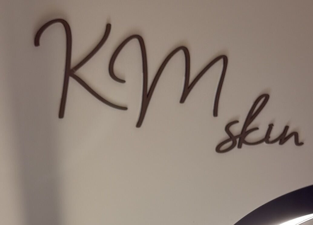 Stylish KM Skin logo on wall at  Clydebank, Scotland, GB.