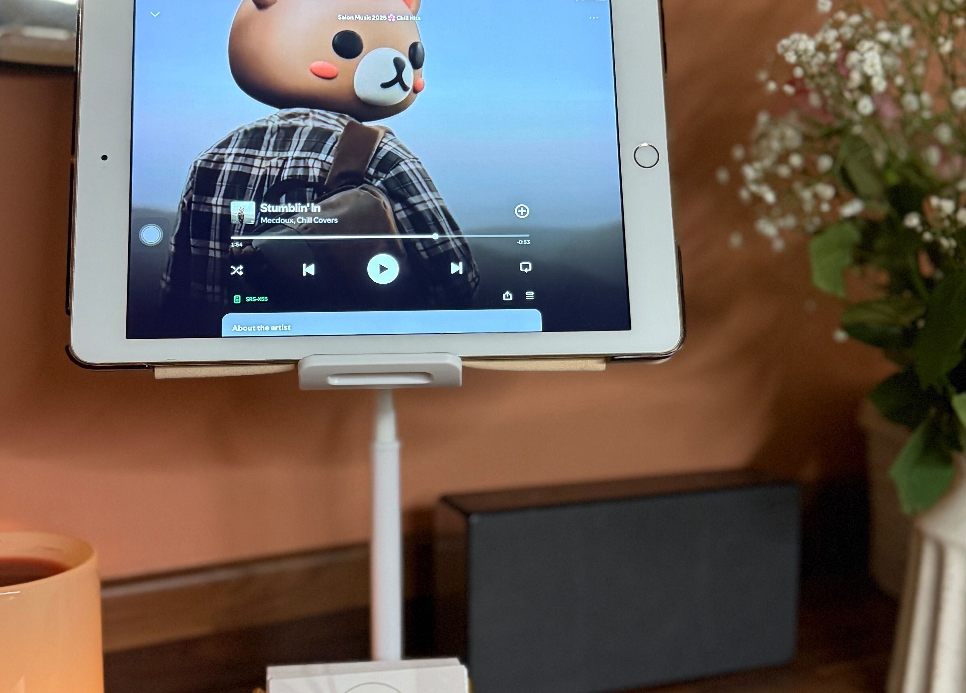 Tablet playing music at KM Skin, Clydebank, Scotland, GB. Cozy ambiance with flowers and a drink.