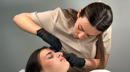 Beauty specialist at MJ Beauty Lounge Il-fgura, MT, performing a precision facial treatment.