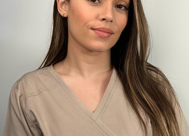 Beauty specialist at MJ Beauty Lounge, Il-fgura, MT, showcasing a professional look in light attire.