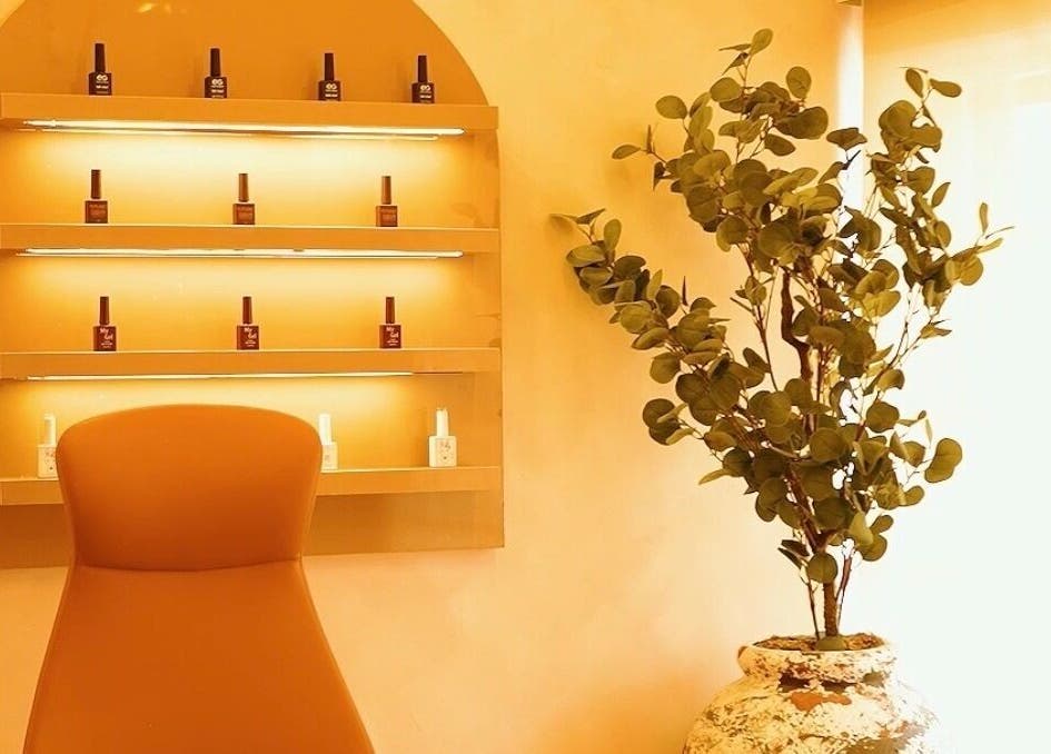 Cozy BK NAILS corner in Abuja with elegant nail polish display and greenery.