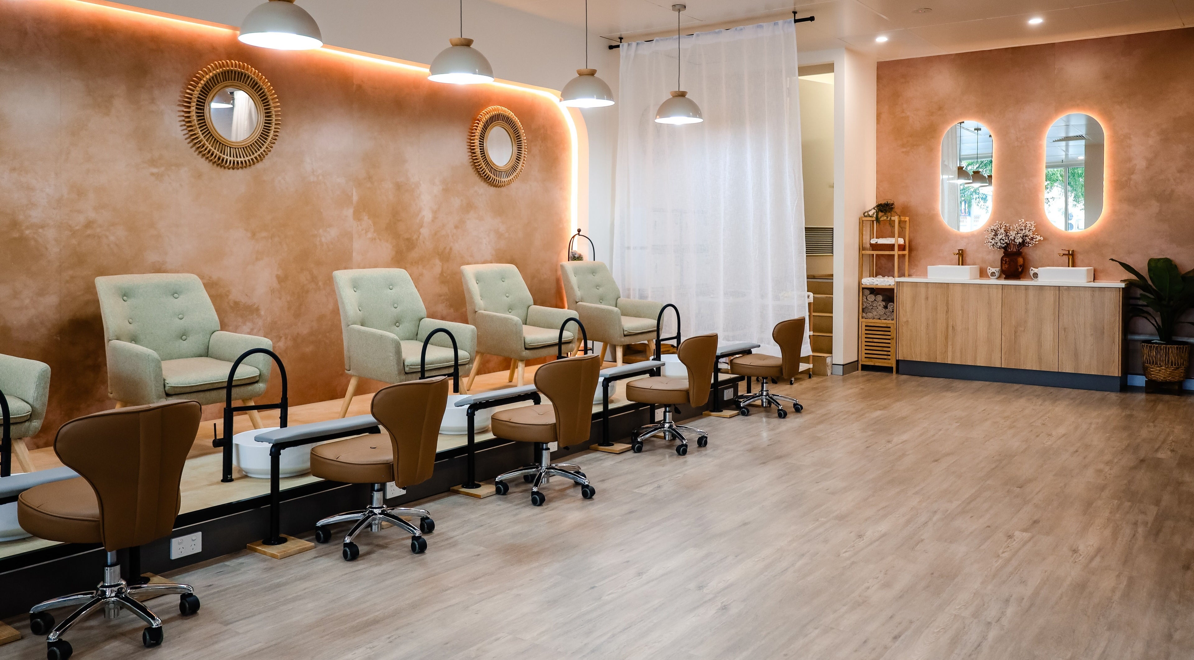 Elegant pedicure area at Serene Retreat & Social Spa in Cairns City, Queensland, AU. Cozy chairs and modern design.