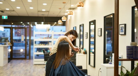 Thi Vo Hair Salon in Calgary, Alberta, CA with a stylist perfecting a haircut.