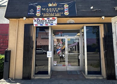 Maestro Cuts Barbershop entrance in Van Nuys, California, US. Welcoming storefront with open sign.