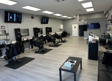Spacious interior of Maestro Cuts Barbershop in Van Nuys, California, US, featuring stylish barber chairs and modern decor.