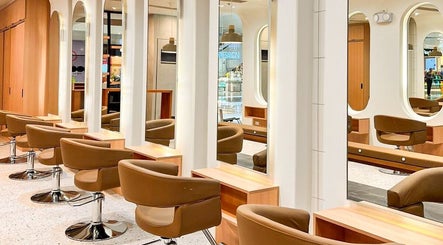 Modern salon interior at Azta Urban Salon - One Ayala, Makati, Metro Manila, PH with sleek styling chairs and mirrors.
