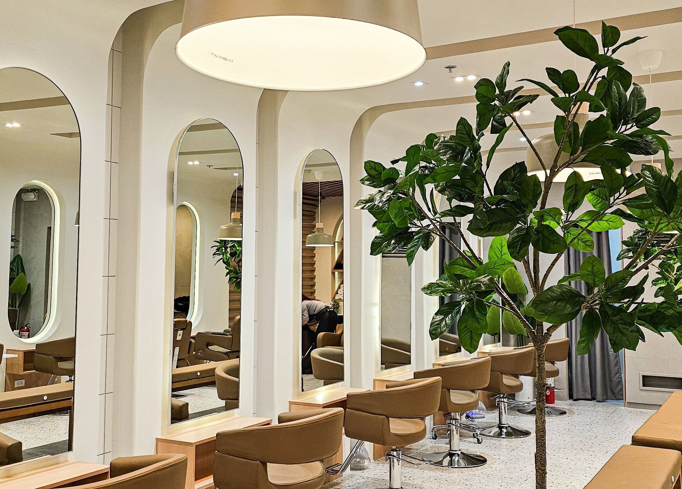 Modern interior of Azta Urban Salon - One Ayala in Makati, Metro Manila, PH, featuring stylish salon chairs and mirrors.