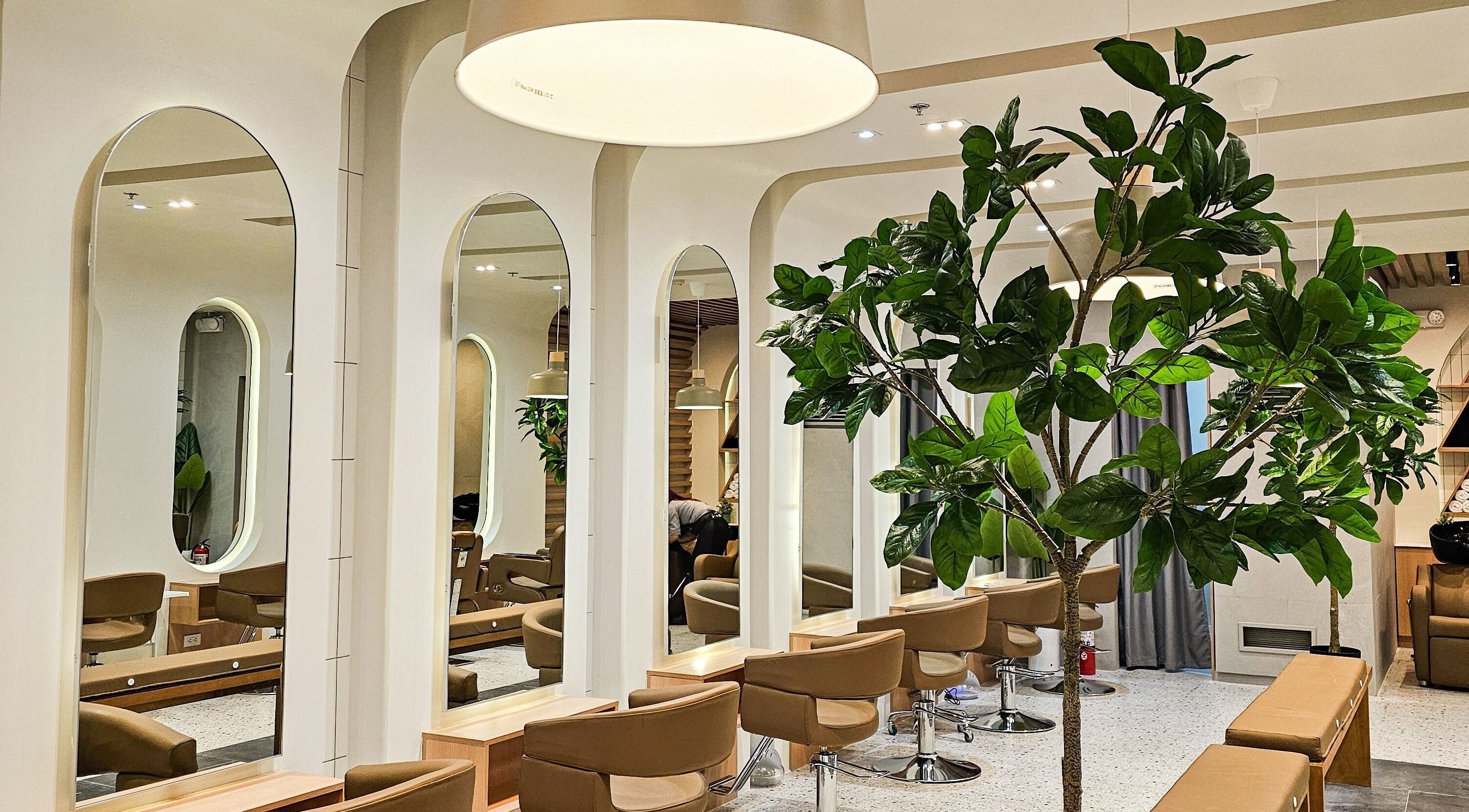Modern interior of Azta Urban Salon - One Ayala in Makati, Metro Manila, PH, featuring stylish salon chairs and mirrors.