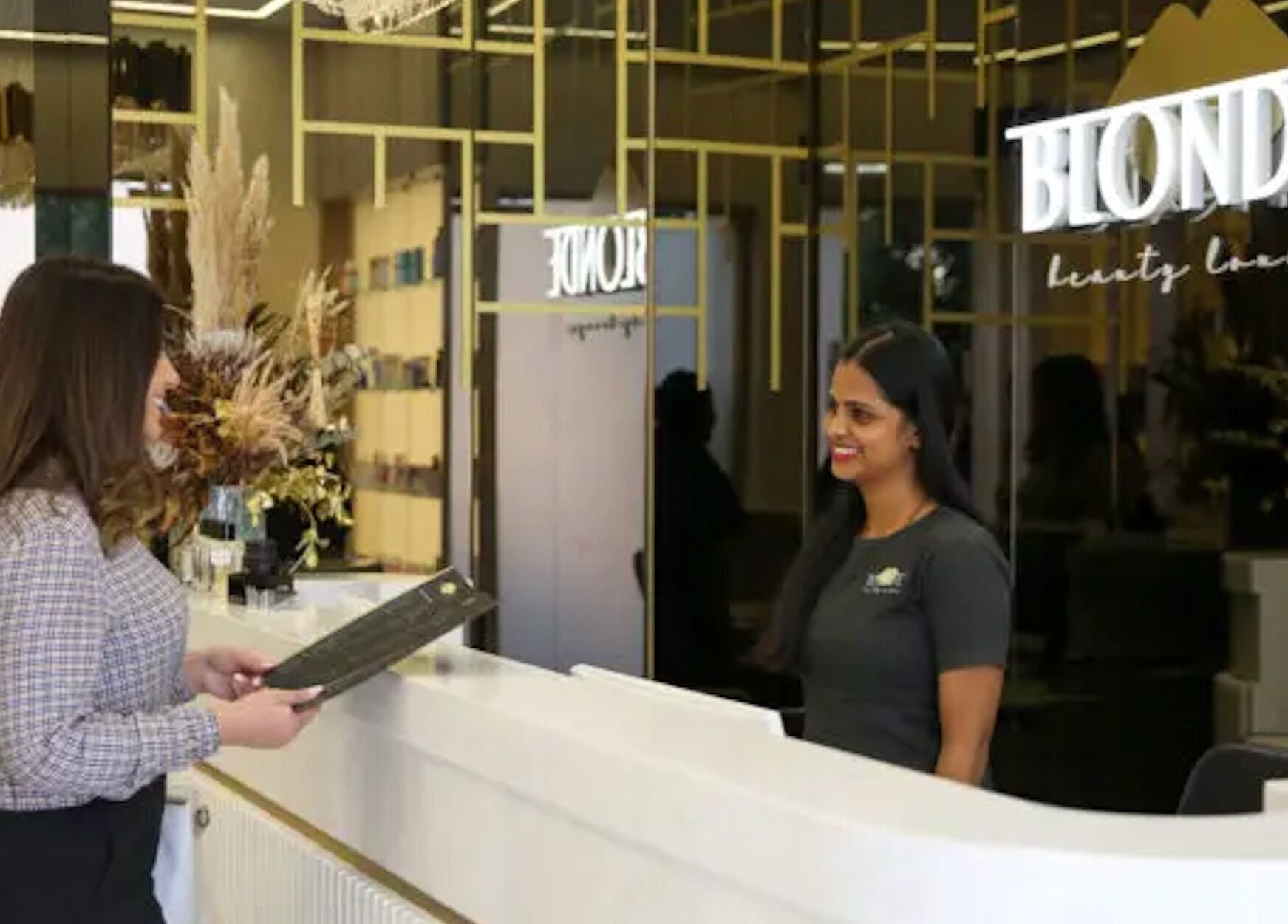 Warm welcome at The Blonde Luxury Salon Khalifa City reception, Abu Dhabi, AE.