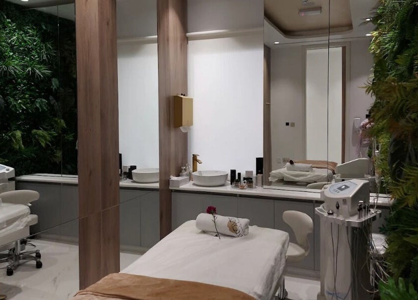 Elegant treatment room at Nine By Blonde Ladies Beauty Lounge Al Bateen, Abu Dhabi, with modern decor and greenery.